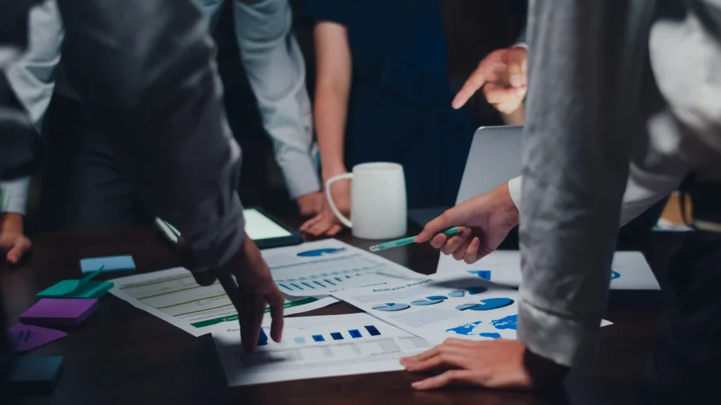 Digital marketing experts in Wayanad analyzing performance graphs and collaborating on growth strategies"